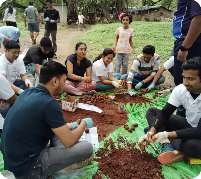 Team collaborating to create seedballs during Worley CSR drive  